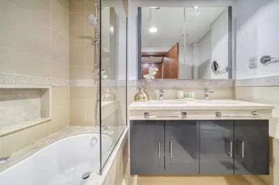 a bathroom with a tub and a sink and a shower at Burj Vista, Downtown Dubai - Burj Khalifa View - Mint Stay in Dubai