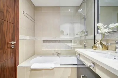 a bathroom with a tub and a sink at Burj Vista, Downtown Dubai - Burj Khalifa View - Mint Stay in Dubai