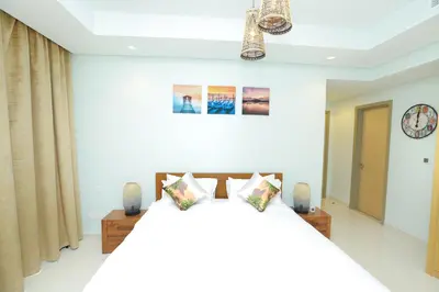a bedroom with a bed and a clock on the wall at Paramount Midtown - Fantastic 2 Bedroom Apartment with Sea View in Dubai