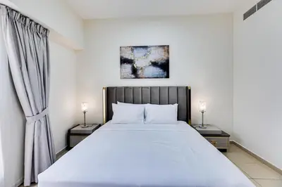 a bedroom with a large bed with two night stands at Wonderful 2BD apartment near The Beach Sadaf Jbr in Dubai