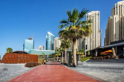 a palm tree and a red road in a city at Wonderful 2BD apartment near The Beach Sadaf Jbr in Dubai