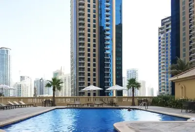 a large swimming pool in a city with tall buildings at Spacious 2 BR with Amazing Marina View Rimal JBR in Dubai