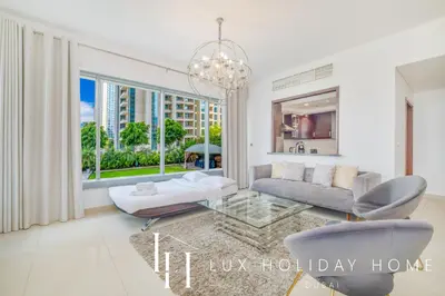 a living room with a couch and a chandelier at LUX - The Downtown Blvd Suite in Dubai