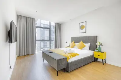 a bedroom with a large bed and a television at Vonder: City Walk in Dubai