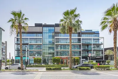 a building with palm trees in front of it at Vonder: City Walk in Dubai
