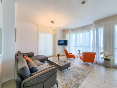 a living room with a couch and a table at The Residence 7 Downtown - Full Burj Khalifa and Fountain Views by Gardenia Suites in Dubai