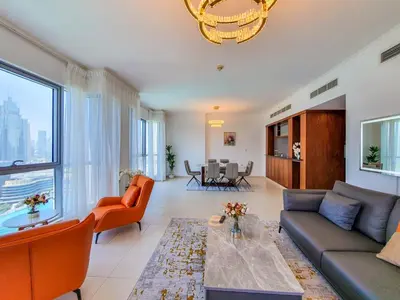 a living room with a couch and a table at The Residence 7 Downtown - Full Burj Khalifa and Fountain Views by Gardenia Suites in Dubai