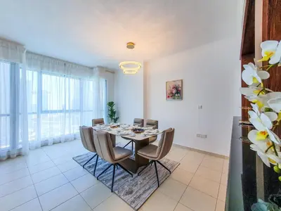a dining room with a table and chairs at The Residence 7 Downtown - Full Burj Khalifa and Fountain Views by Gardenia Suites in Dubai