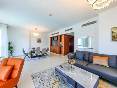 a living room with a couch and a table at The Residence 7 Downtown - Full Burj Khalifa and Fountain Views by Gardenia Suites in Dubai