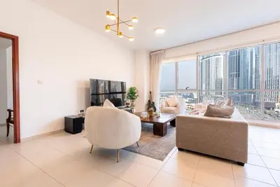 a living room with a couch and chairs and a table at Splendid 3BR Apartments - Burj Khalifa & Fountain Views - 5 Minutes Walk from Dubai Mall in Dubai