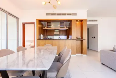 a dining room with a table and chairs at Splendid 3BR Apartments - Burj Khalifa & Fountain Views - 5 Minutes Walk from Dubai Mall in Dubai