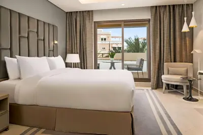 a bedroom with a large bed and a balcony at Wyndham Residences The Palm in Dubai
