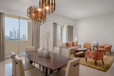 a dining room and living room with a table and chairs at Marriott Executive Apartments Al Jaddaf, Dubai in Dubai