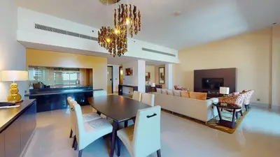 a dining room and living room with a chandelier at Marriott Executive Apartments Al Jaddaf, Dubai in Dubai