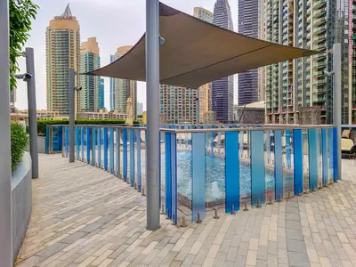 awning over a swimming pool on a balcony with buildings at EDEN'S Homes & Villas - Opera Grand in Dubai