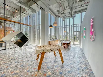 a room with a table and a tv in it at GuestReady - In the Heart of Dubai Hills in Dubai
