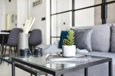 a glass coffee table with a plant on top of it at GuestReady - In the Heart of Dubai Hills in Dubai