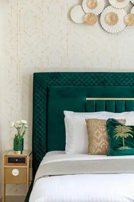 a bedroom with a green headboard and a white bed at Frank Porter - Sobha Creek Tower B in Dubai