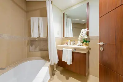 a bathroom with a bath tub and a sink at Luxury 2BR Sea & Skyline Views Near Metro & Burj Khalifa in Dubai