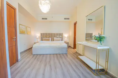 a bedroom with a bed and a large mirror at Luxury 2BR Sea & Skyline Views Near Metro & Burj Khalifa in Dubai
