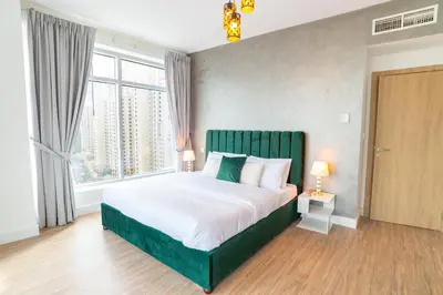 a bedroom with a large bed and a large window at Luxury Escapes - Full Marina View Luxury 2BR - Park Island Sanibel in Dubai