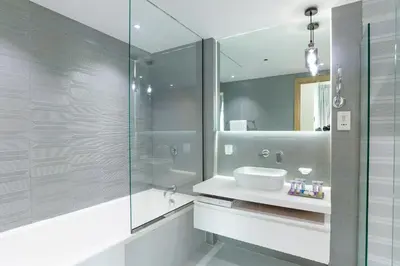 a bathroom with a sink and a glass shower at Luxury Escapes - Full Marina View Luxury 2BR - Park Island Sanibel in Dubai