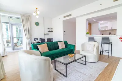 a living room with a green couch and two chairs at Luxury Escapes - Full Marina View Luxury 2BR - Park Island Sanibel in Dubai