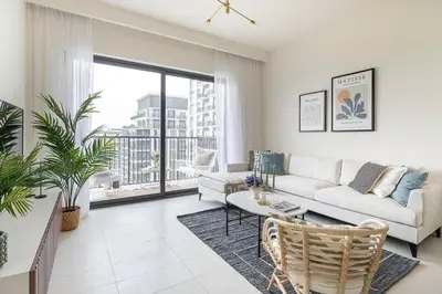 a living room with a couch and a table at Frank Porter - Park Ridge C in Dubai