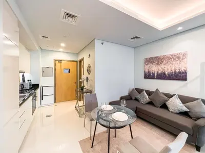 a living room with a couch and a table at Luton Vacation Homes - Damac Paramount Midtown Business Bay Dubai - 37AB09 in Dubai