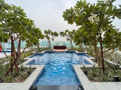 a swimming pool in a resort with trees at Luton Vacation Homes - Damac Paramount Midtown Business Bay Dubai - 37AB09 in Dubai
