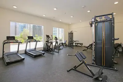 a gym with treadmills and exercise equipment in a room at AG Tower - 1BR Apartment - Allsopp&Allsopp in Dubai