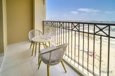 a balcony with a table and chairs and a view of the beach at Exclusive Deal Stunning 1BR at Madinat Jumeirah by Deluxe Holiday Homes in Dubai