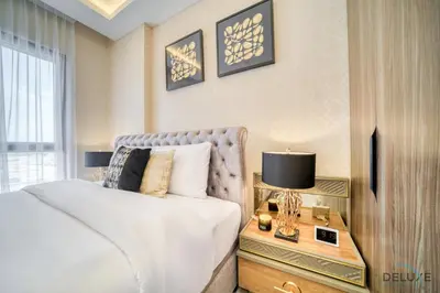 a bedroom with a bed and a table with a lamp at Exclusive Deal Stunning 1BR at Madinat Jumeirah by Deluxe Holiday Homes in Dubai