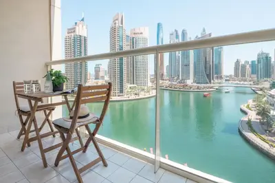 a balcony with a table and chairs and a view of a river at Frank Porter - Marina Views B in Dubai