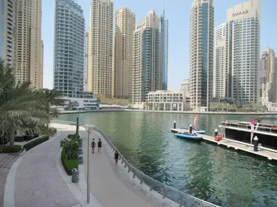 a river in a city with tall buildings at Frank Porter - Marina Views B in Dubai