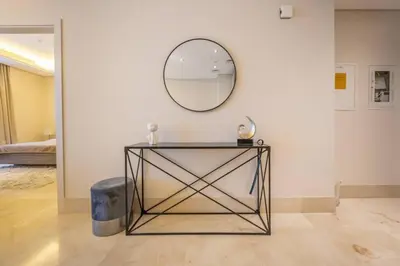 a table in a room with a mirror on the wall at Cozy beachfront 1 bedroom apartment - The 8 in Dubai