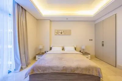 a bedroom with a large bed with two night stands at Cozy beachfront 1 bedroom apartment - The 8 in Dubai