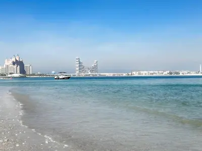 a view of a beach with a city in the background at Cozy beachfront 1 bedroom apartment - The 8 in Dubai