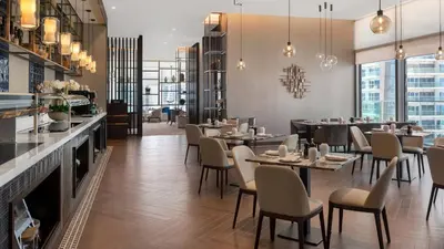 a restaurant with tables and chairs and a bar at Desert Living Luxury Condo - Jumeirah Living Marina Gate in Dubai