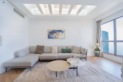 a living room with a couch and a table at JBR Amwaj 4 , Upgraded Sea and Ain Dubai Views, 2m walk to Beach By Gardenia Suitse in Dubai