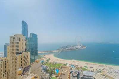 a view of a beach and the ocean with buildings at JBR Amwaj 4 , Upgraded Sea and Ain Dubai Views, 2m walk to Beach By Gardenia Suitse in Dubai