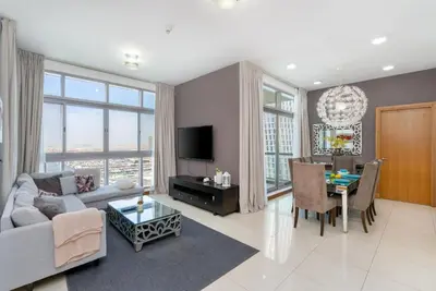 a living room with a couch and a table at Vacay Lettings - 2BHK with Dubai Marina View in Dubai