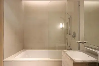 a bathroom with a bath tub and a sink at Prime 1BR with Marina Views and Beach Access in Dubai