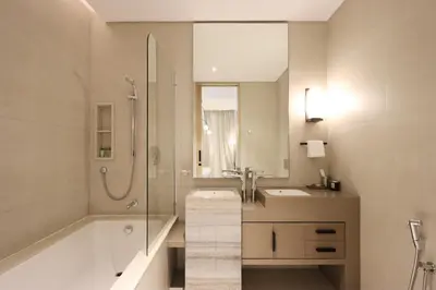 a bathroom with a tub and a sink and a shower at Prime 1BR with Marina Views and Beach Access in Dubai