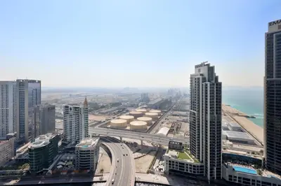 an aerial view of a city with tall buildings at Prime 1BR with Marina Views and Beach Access in Dubai