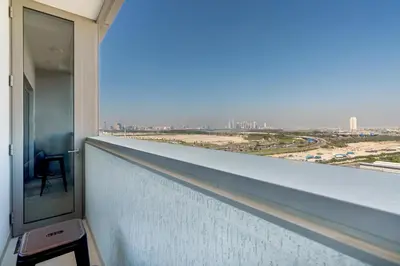a balcony of a building with a view of a city at White Sage - Elegant Apartment With Unobstructed City Views in Dubai