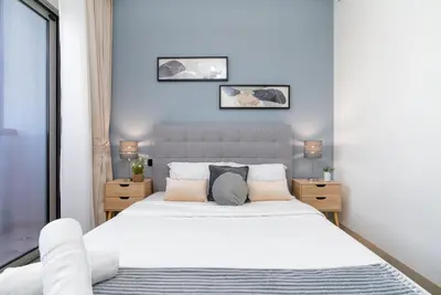 a bedroom with a large bed with white sheets and pillows at White Sage - Elegant Apartment With Unobstructed City Views in Dubai