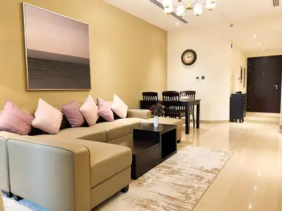 a living room with a couch and a table at Luton Vacation Homes - Elite Downtown Residence, Burj Khalifa View Dubai - 19AB01 in Dubai