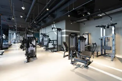 a gym with rows of treadmills and machines at Luxury Studios with Burj Khalifa View or Canal view - Marquise Square Tower in Dubai