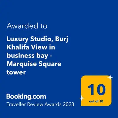 a screenshot of a cell phone with a yellow sign at Luxury Studios with Burj Khalifa View or Canal view - Marquise Square Tower in Dubai